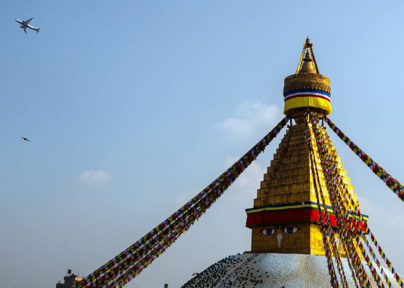 2024, Nepal, Kathmandu, Bodnath ist ein Pilgerort der Tibeter, wurde nach seinem riesigen Stupa benannt. Pilger gehen um die weisse Kuppel, die mit Buddha-Augen bemalt ist.