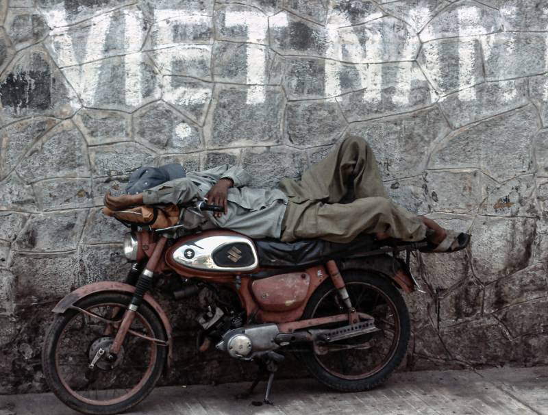 1984, Schlafender auf dem Motorrad.